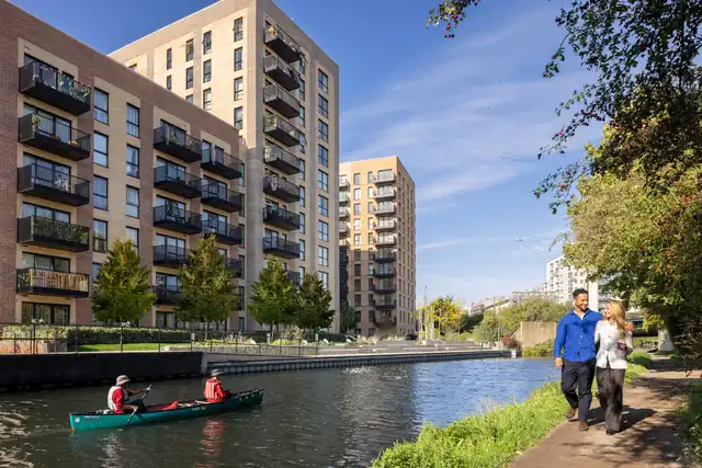 Hayes Village apartments beside the Grand Union Canal, with a canoe on the water