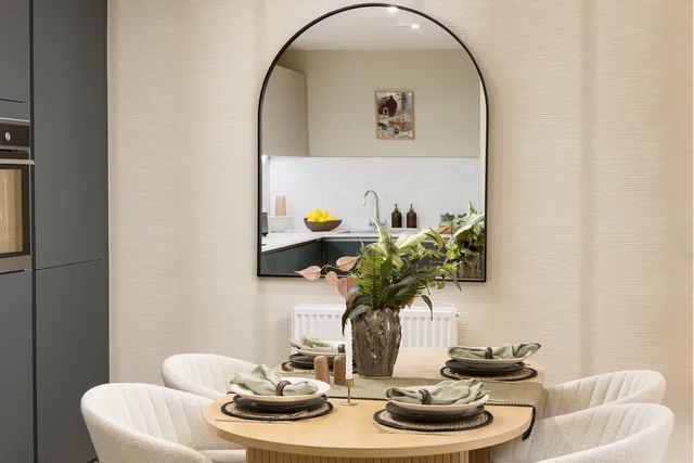 Hendon Waterside show home dining table in front of a large mirror