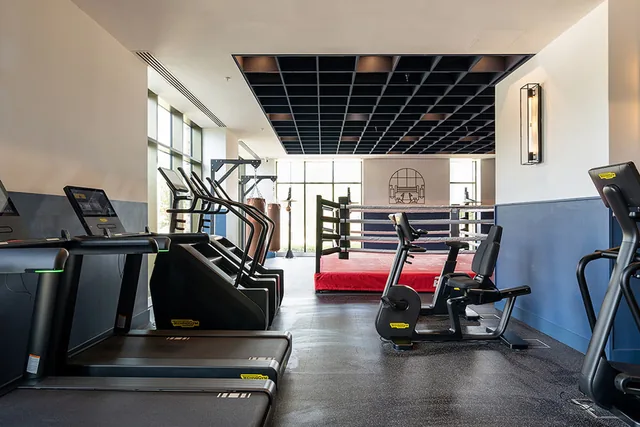 Cardio machines and a boxing ring in the residents’ gym at Bow Green