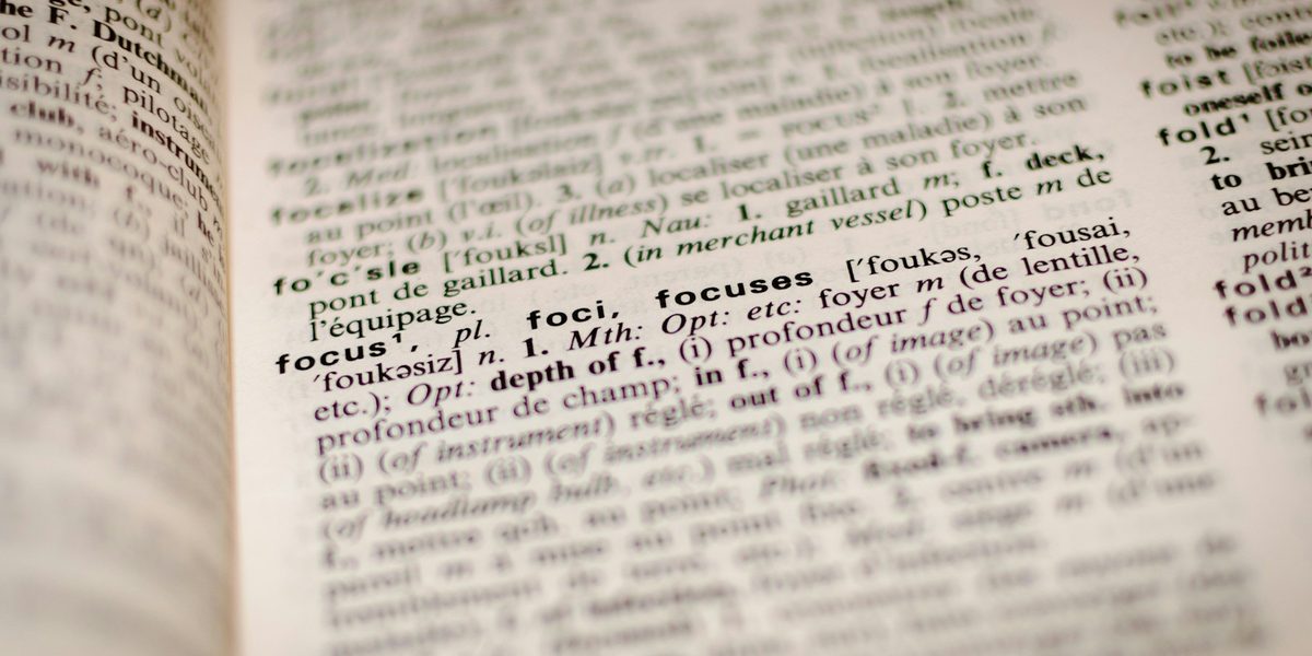 Close-up of a bilingual dictionary page open at the word focus