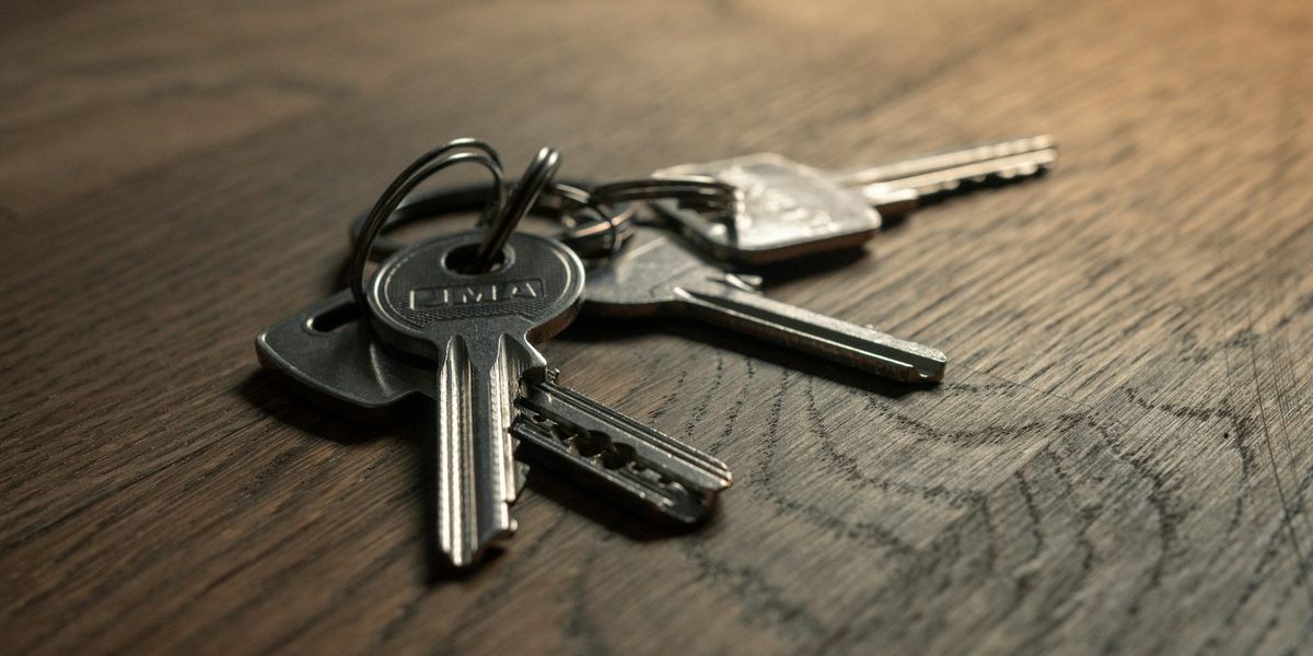 A bunch of house keys on a wooden table