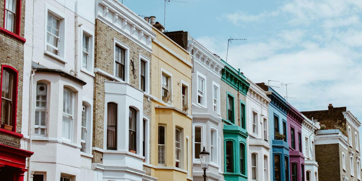 A row of painted Victorian terraced houses in London